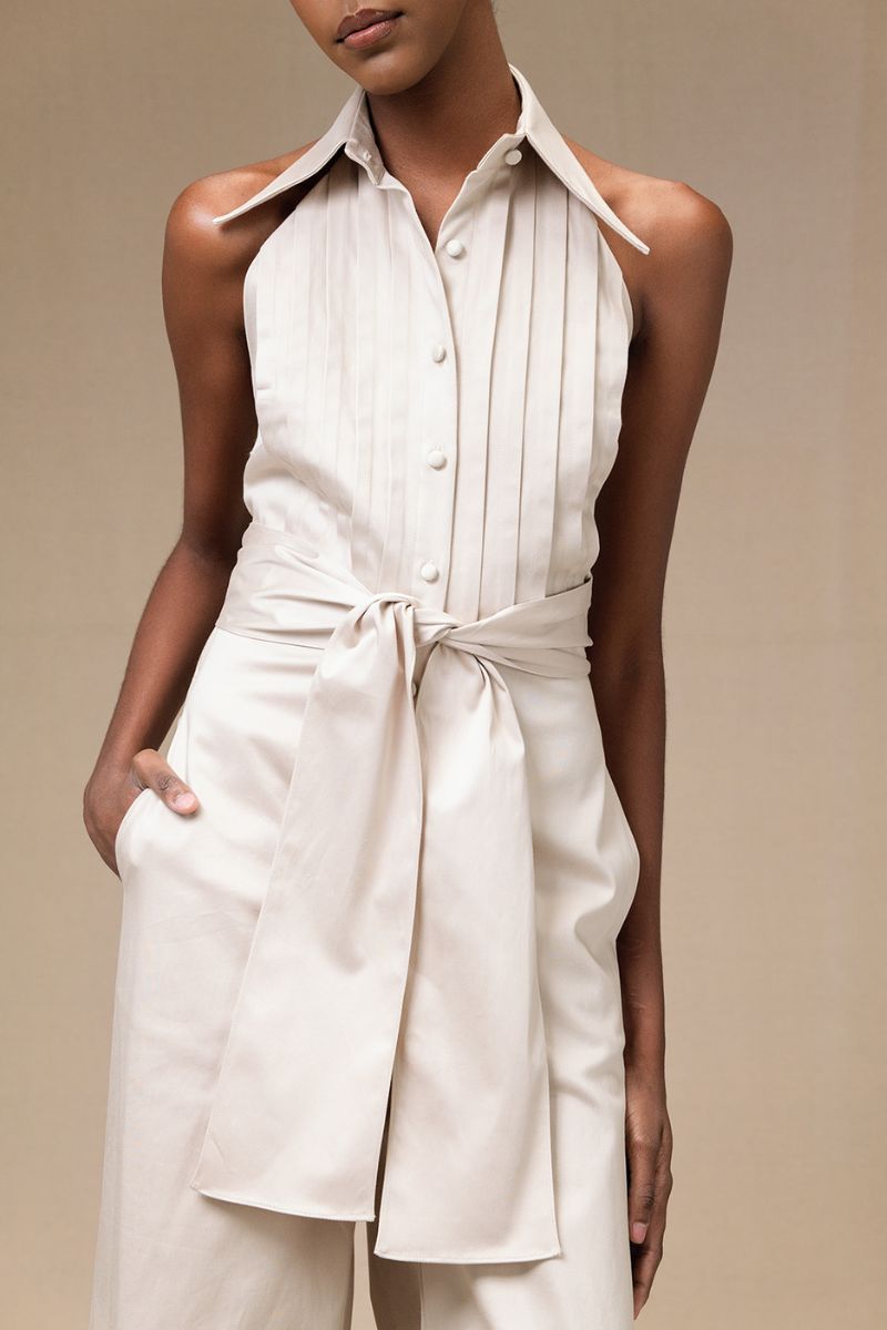 ANA + MARIA wrapped jumpsuit in sand color, featuring a stylish design and comfortable fit, shown on a model.