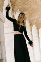 Black Nana Jacqueline Thea top with a sleek design, shown on a model in a fashion campaign shot.