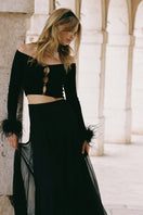 Black Nana Jacqueline Thea Top made of soft fabric, displayed on a mannequin with a sleek, modern design.
