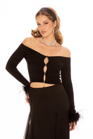 Black Thea top by Nana Jacqueline, stylish sleeveless blouse with a fitted silhouette, shown on a model.