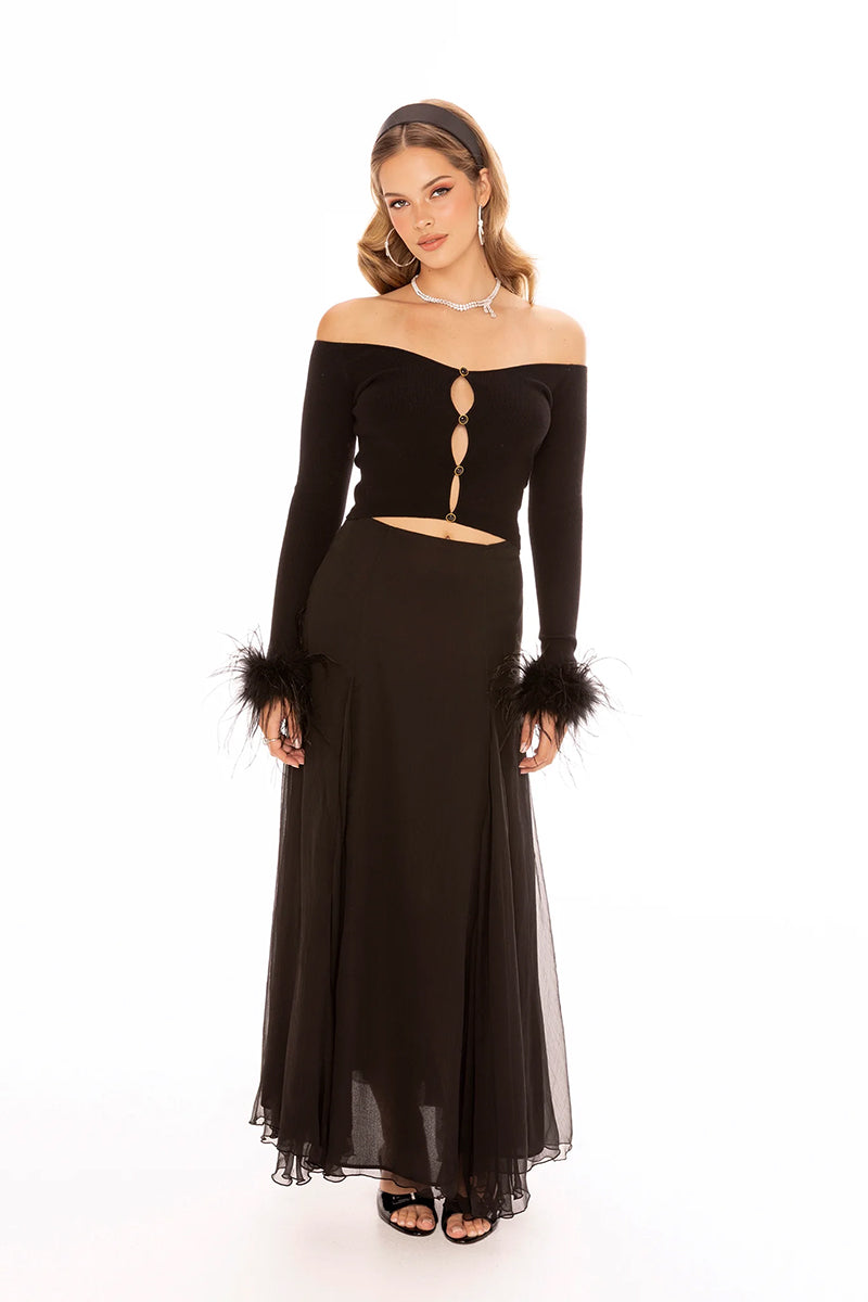 Black Nana Jacqueline Thea top displayed on a model, showcasing its stylish design and fit.