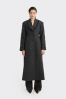 Black Thread Coat by Stolen Stores, stylish outerwear with a sleek design, shown on a hanger against a plain background.