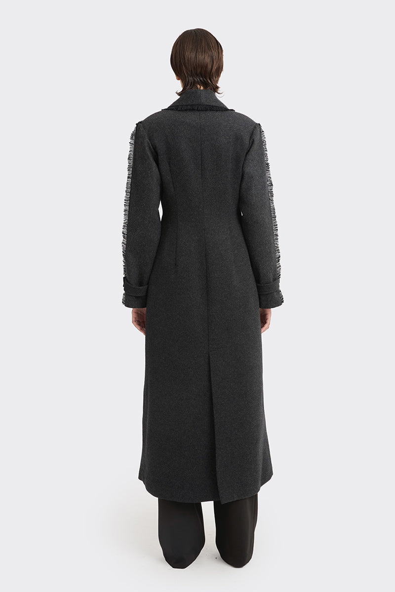Black Thread Coat by Stolen Stores, stylish outerwear with a sleek design, shown on a model with a modern urban background.