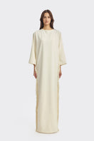 Ivory white maxi dress with long sleeves and fringe details from Stolen Stores, featuring a flowing, elegant design.