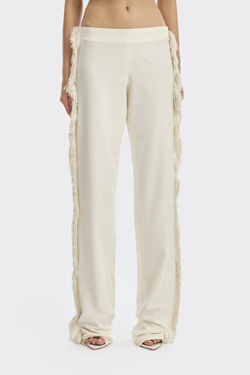 Ivory white thread fringe maxi pants by Stolen Stores featuring flowing fabric and intricate fringe detailing.