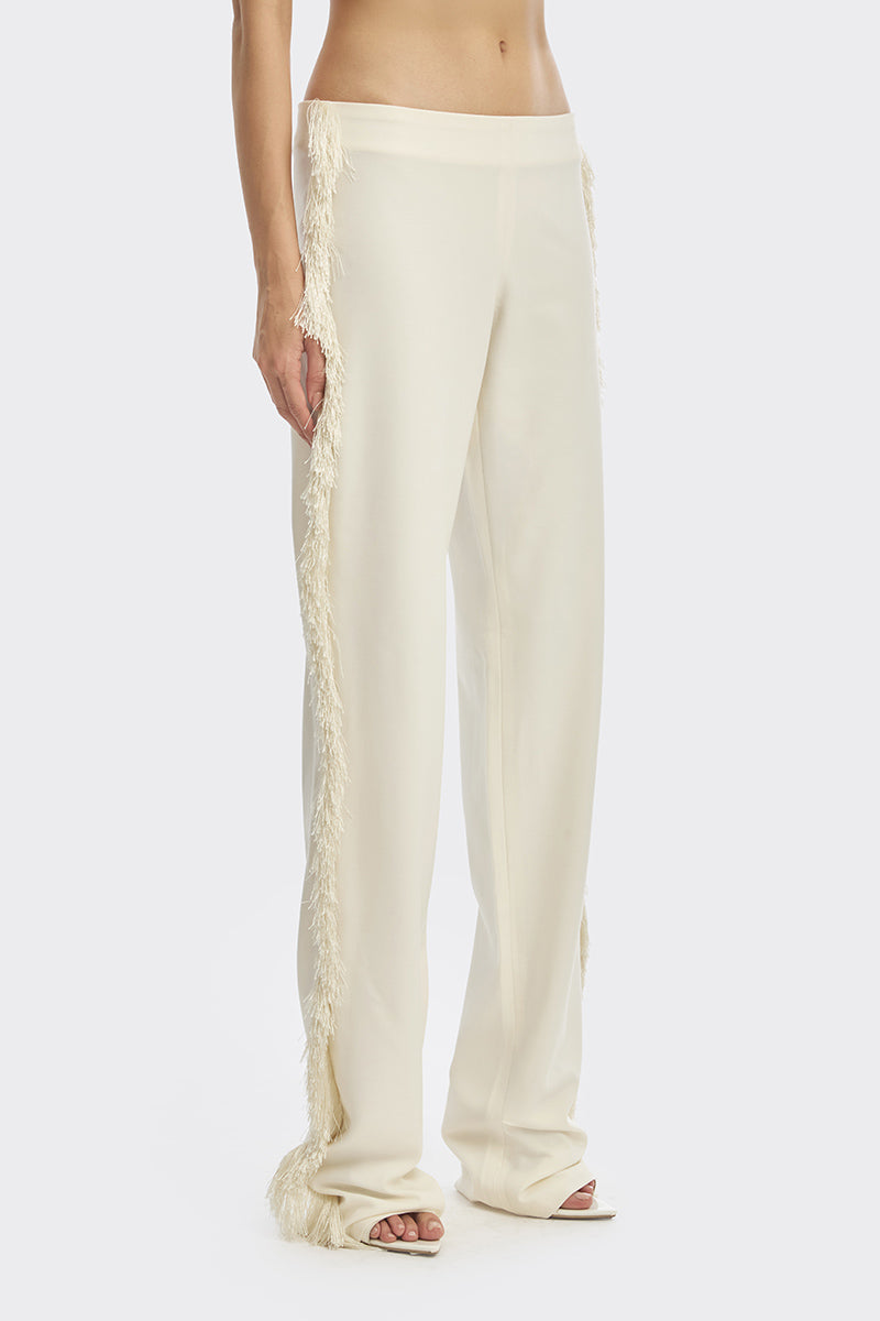 Ivory white thread fringe pants by Stolen Stores, featuring flowing maxi style and detailed fringe embroidery.