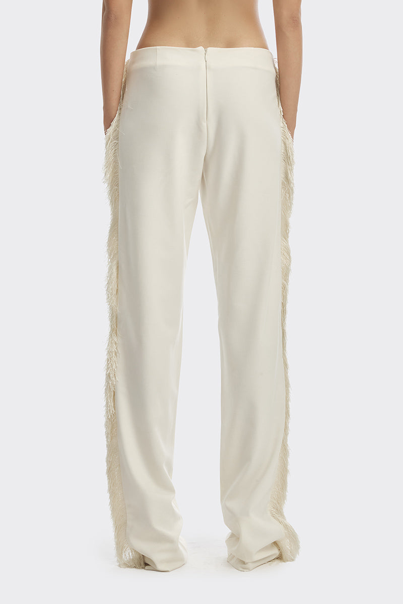 Ivory white thread fringe maxi pants from Stolen Stores with intricate fringe detailing and relaxed fit.