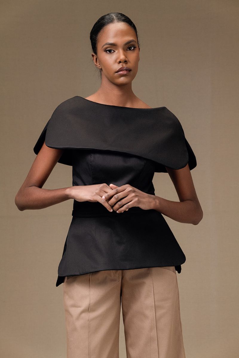 Black Tibet Top by ANA + MARIA, front view showing the stylish, fitted black top with a round neckline and smooth fabric.