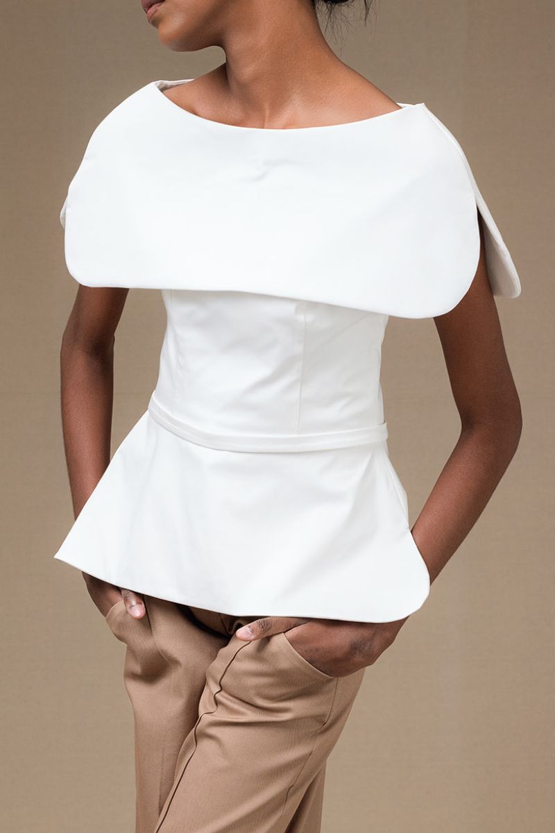 Ivory Tibet Top by ANA + MARIA displayed on a mannequin, showcasing its stylish design and soft fabric.