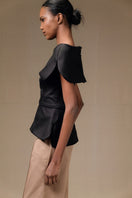 Black Tibet top by ANA + MARIA displayed on a model, featuring a relaxed fit and stylish design perfect for casual wear.