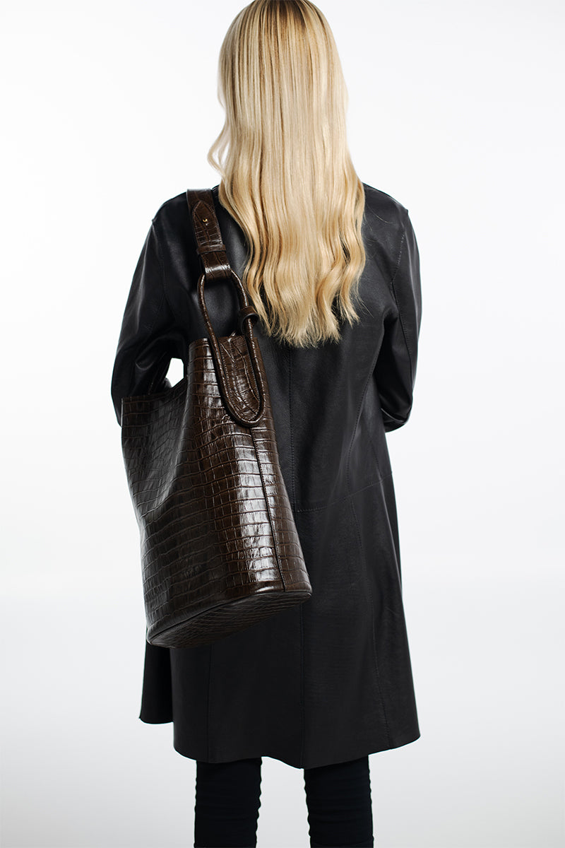 Isidora Malva Tierralta tote shoulder bag with crocodile print in brown and beige, featuring a spacious design and sturdy handles.