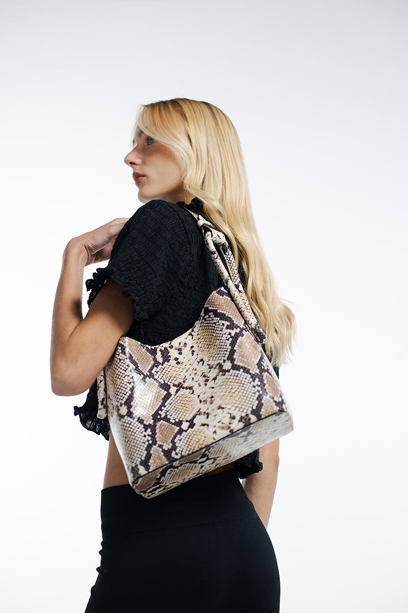 ISIDORA MALVA Tierranueva tote bag with snake print, top handle design, stylish and versatile accessory for everyday use.