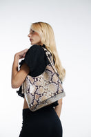 ISIDORA MALVA Tierranueva tote bag with snake print, top handle design, stylish and versatile accessory for everyday use.