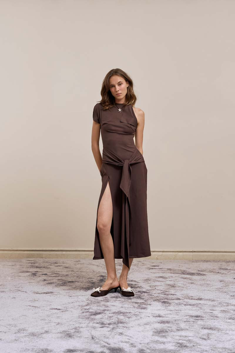 Brown YASSMIN SALEH tilt midi dress with a fitted bodice and flowing skirt, displayed from the front.