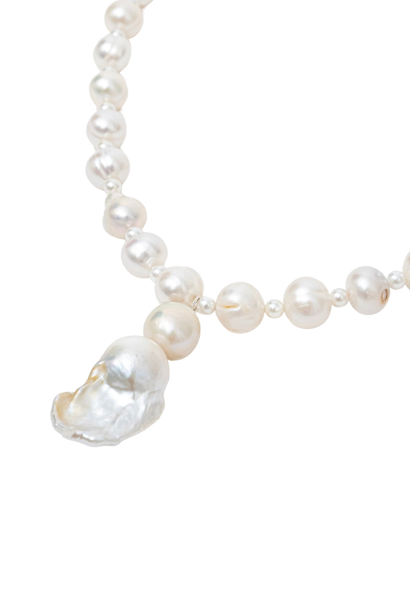Elegant pearl baroque necklace by Oz Objects featuring intricate, timeless design with lustrous irregular pearls.