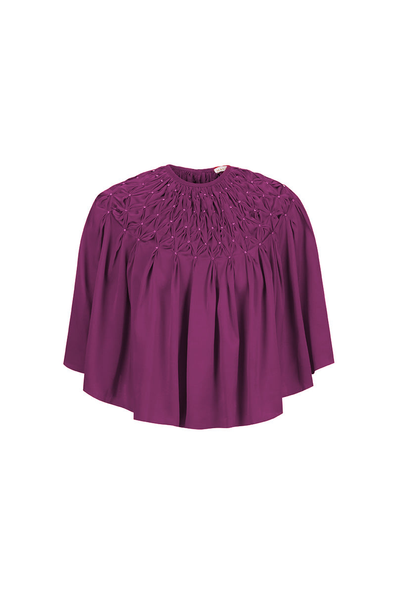 HAND-SMOCKED CAPE IN AUBERGINE