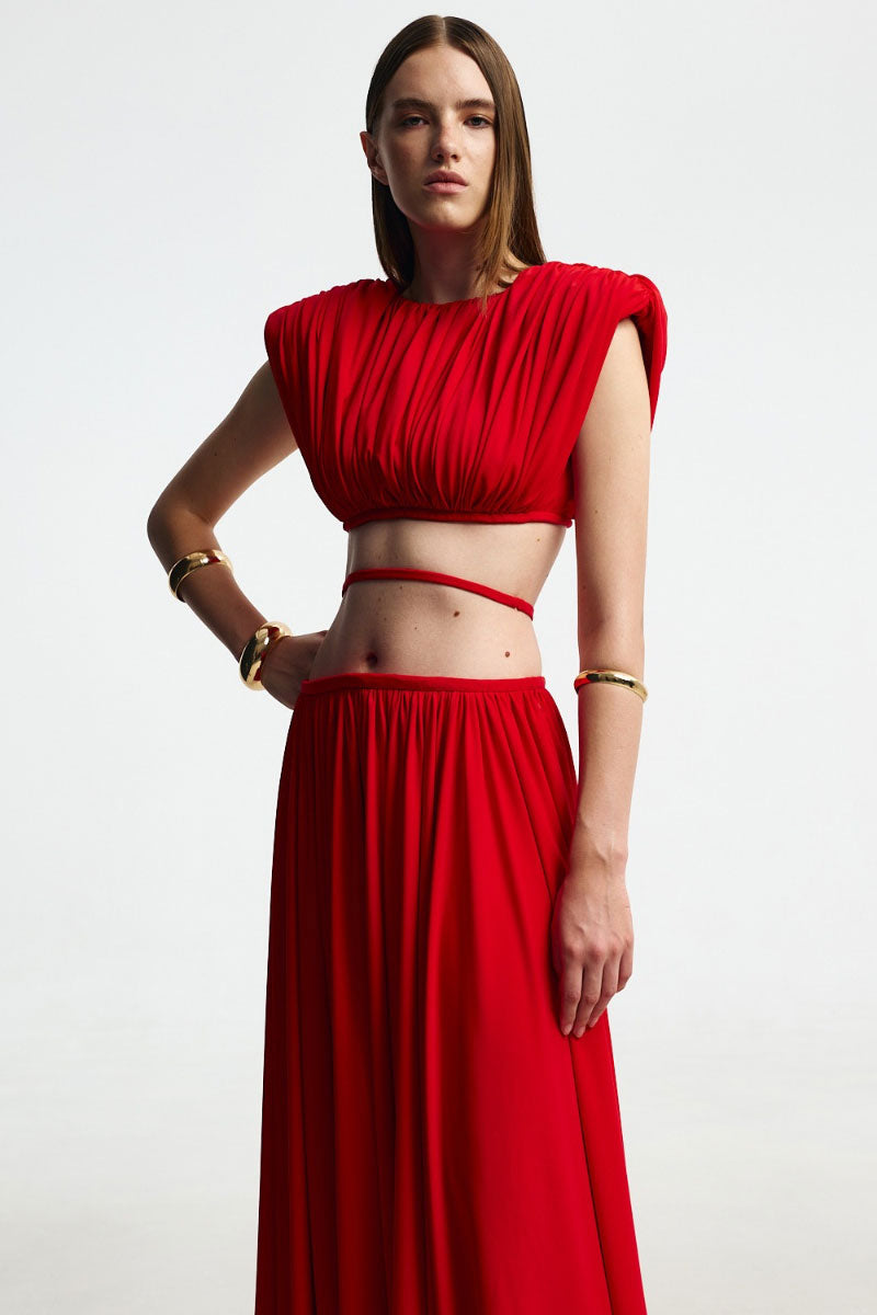 Red wide-shoulder top from Santa Brands, showcasing its stylish design and vibrant color on a casual outfit.