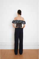 Black YASSMIN SALEH TRACE corset top displayed from the back, showcasing the fitted design and lace-up detail.