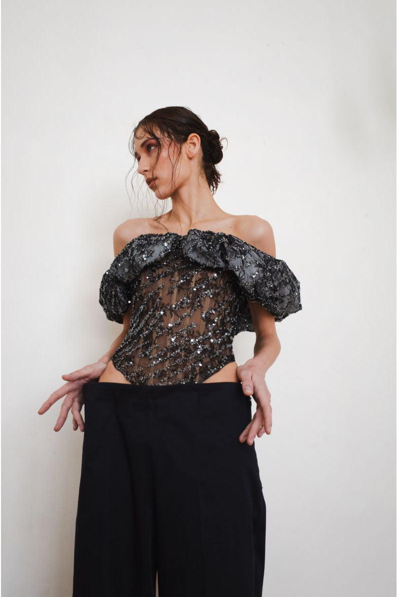 Black YASSMIN SALEH Trace corset top with structured front and fitted design, displayed from the front view.