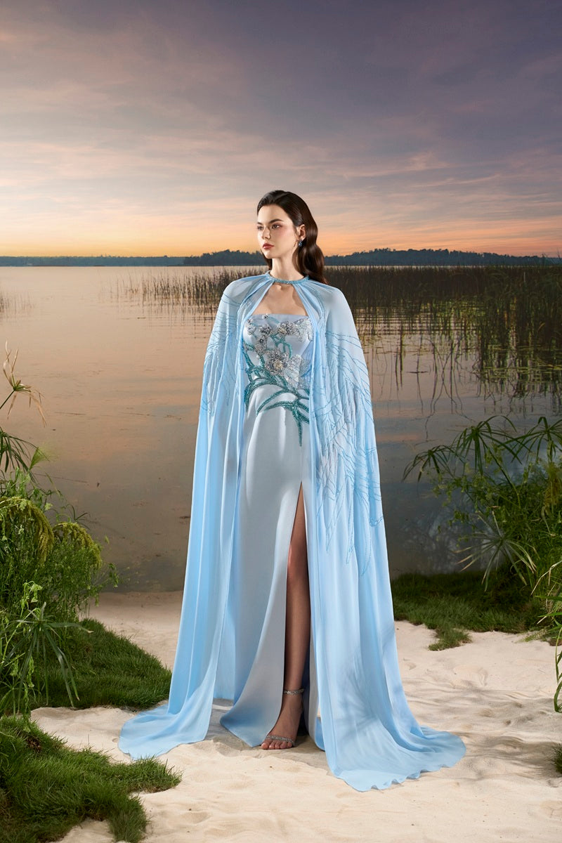 Blue chiffon maxi dress with cape by Tracy Studio, flowing fabric and elegant design perfect for formal occasions.