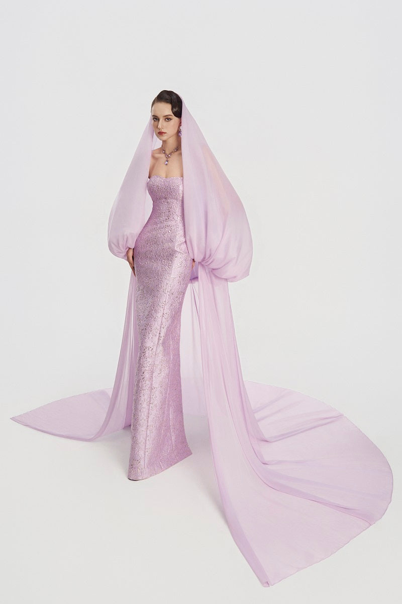 Elegant jacquard maxi gown with a hooded veil cape from Tracy Studio, featuring intricate patterns and flowing fabric.