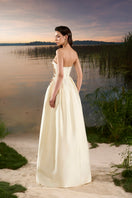 Elegant off-white taffeta strapless A-line gown by Tracy Studio, featuring a fitted bodice and flowing skirt.
