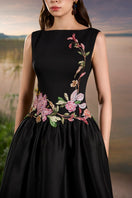Black crepe embellished gown by Tracy Studio featuring intricate detailing and elegant design.