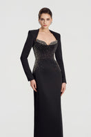 Elegant black embellished gown by Tracy Studio featuring intricate beadwork and flowing fabric, perfect for formal occasions.