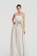 White lace beaded gown by Tracy Studio with intricate beadwork and elegant design, shown on a model.