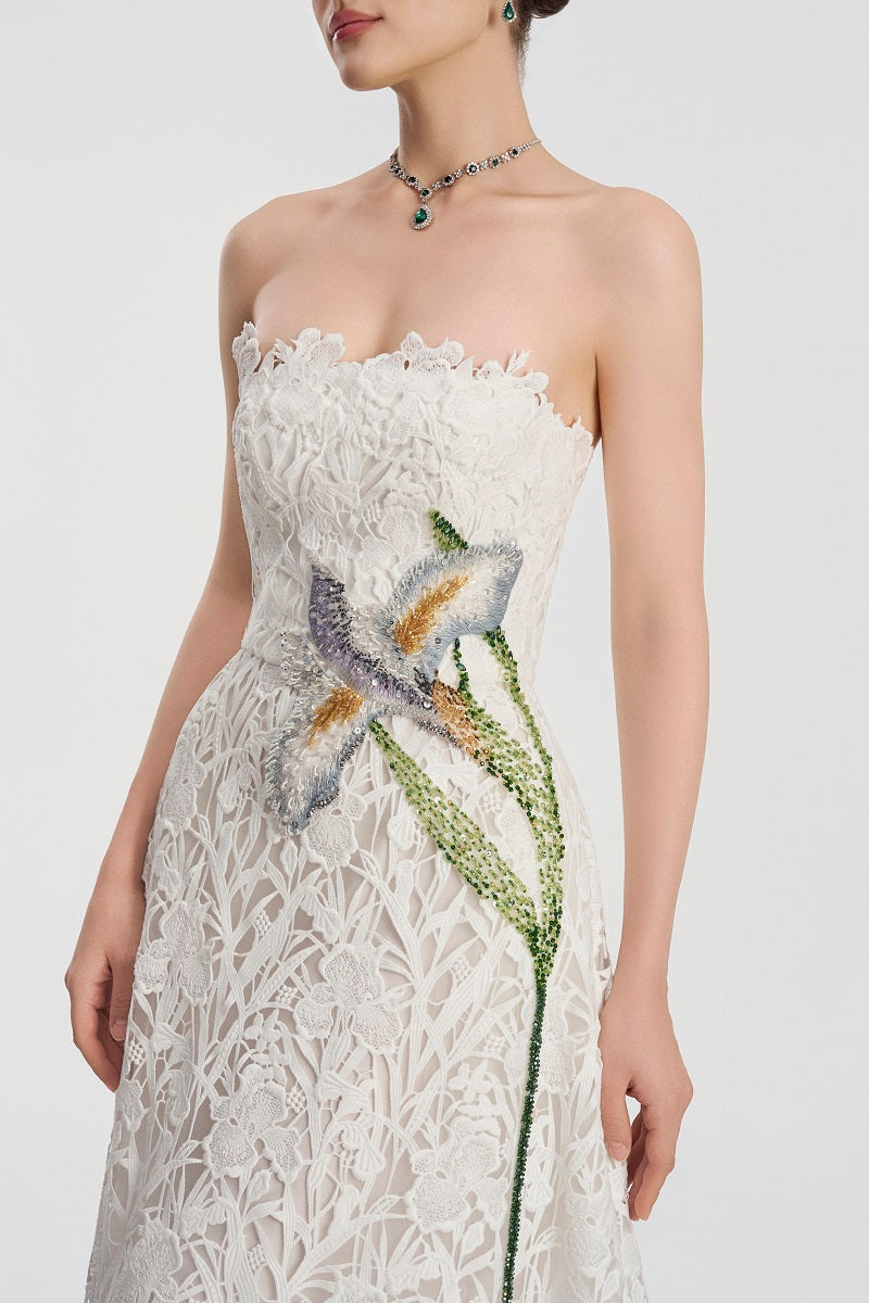 White lace beaded maxi dress by Tracy Studio, featuring intricate beadwork and flowing fabric for elegant occasion wear.