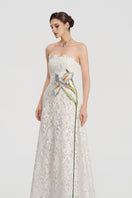 White lace beaded gown by Tracy Studio featuring intricate beadwork and elegant flowing fabric.