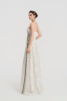 White lace beaded gown by Tracy Studio, featuring intricate beadwork and elegant flowing fabric suitable for formal occasions.