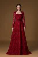 Red I.H.F gown featuring square guipure lace and silk fabric with a trapeze neckline and long sleeves.