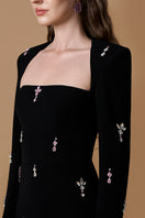 Elegant black crepe de chine gown by I.H.F featuring a trapeze neck and long sleeves with pink stones detail.