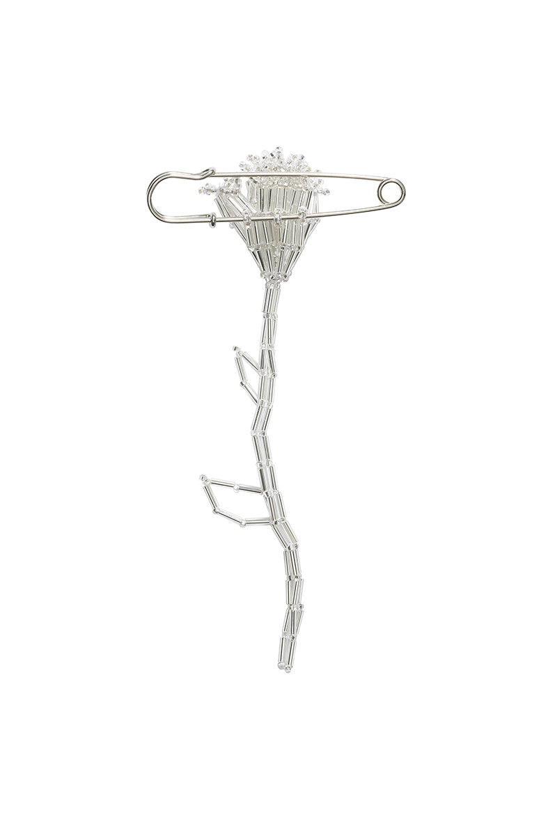 Silver tulip-shaped body jewelry brooch by Pura Utz, featuring intricate floral design and delicate craftsmanship.