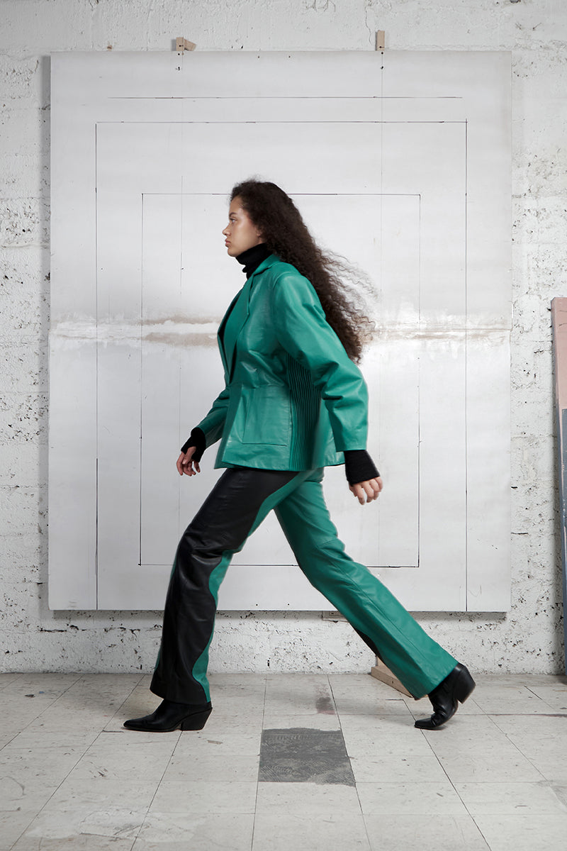 Black and Milano Green two-tone leather trousers by MAZ Manuela Álvarez featuring mountain-inspired design and tailored fit.
