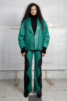 Two-tone leather Mountain trousers in black and Milano green by MAZ Manuela Álvarez, showing the stylish design and color contrast.