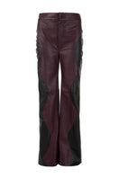 Black and wine red two-tone leather trousers by MAZ Manuela Álvarez featuring mountain-inspired design and tailored fit.