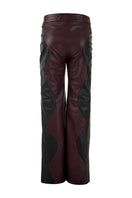 Black and wine red two-tone leather trousers by MAZ Manuela Álvarez with mountain-inspired design and tailored fit.