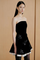 Black Urban Muse velours mini dress displayed on a mannequin, showcasing the fitted silhouette and soft fabric texture.
