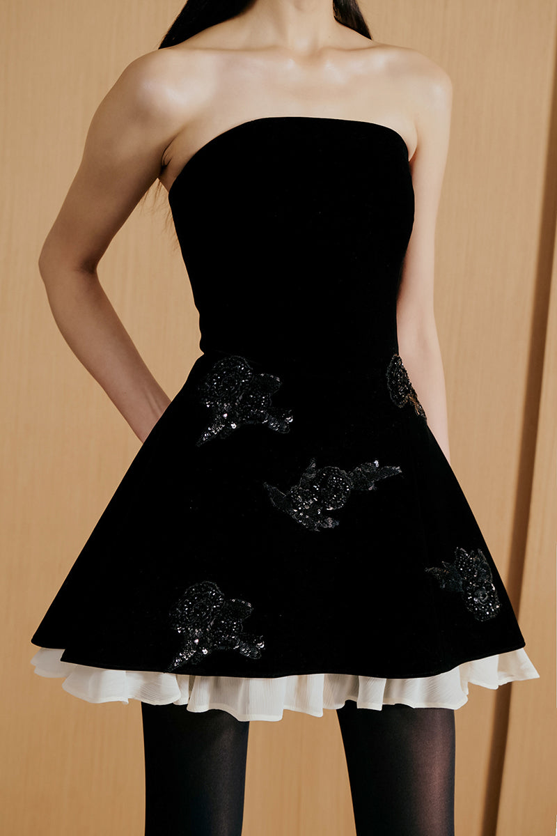 Black Urban Muse velours mini dress, close-up of the fitted silhouette and soft fabric detail.
