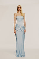 Sky blue URBAN MUSE CLYMENE maxi dress displayed on a model, featuring flowing fabric and elegant design.