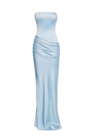 Sky blue URBAN MUSE CLYMENE maxi dress displayed on a hanger, featuring flowing fabric and a stylish, elegant silhouette.