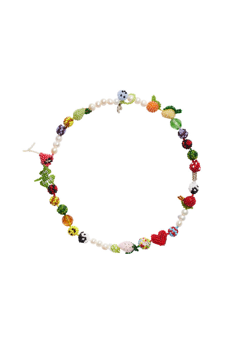 Pura Utz Un Poco Loco necklace featuring colorful beads and unique pendant, styled on a chain for a vibrant, bohemian look.