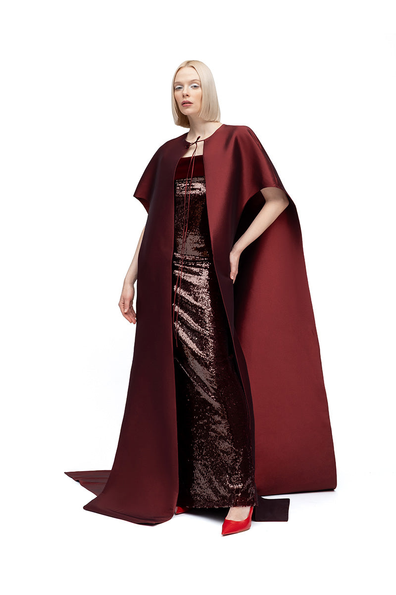Moon Hakaan Yildirim Lily Cape in wine, stylish jacket with flowing fabric and elegant design, displayed on a hanger.