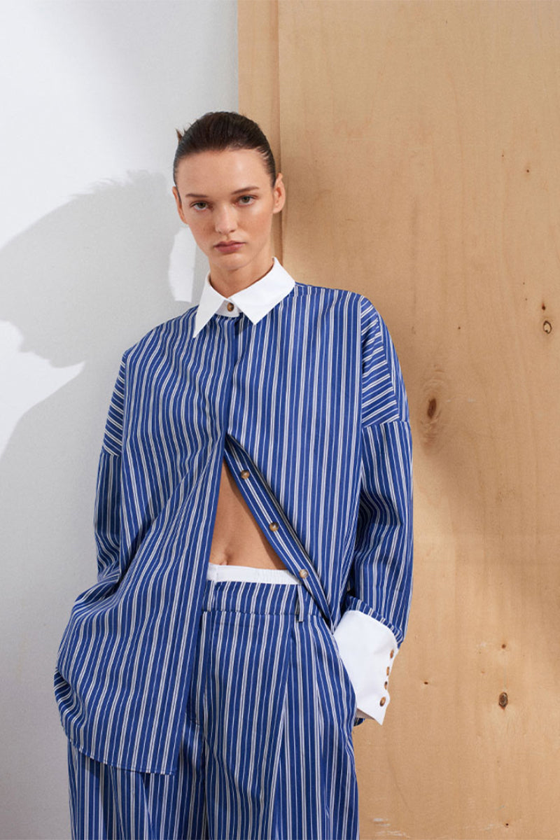 Acaria Studio ICONIC NY Navy and White Shirt displayed flat, showcasing its classic design and color-block pattern.