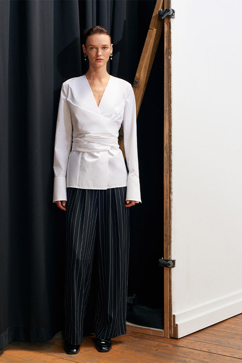 White JOURNEY shirt by Acaria Studio, plain long-sleeve shirt with collar and button-front, displayed flat on a white background.