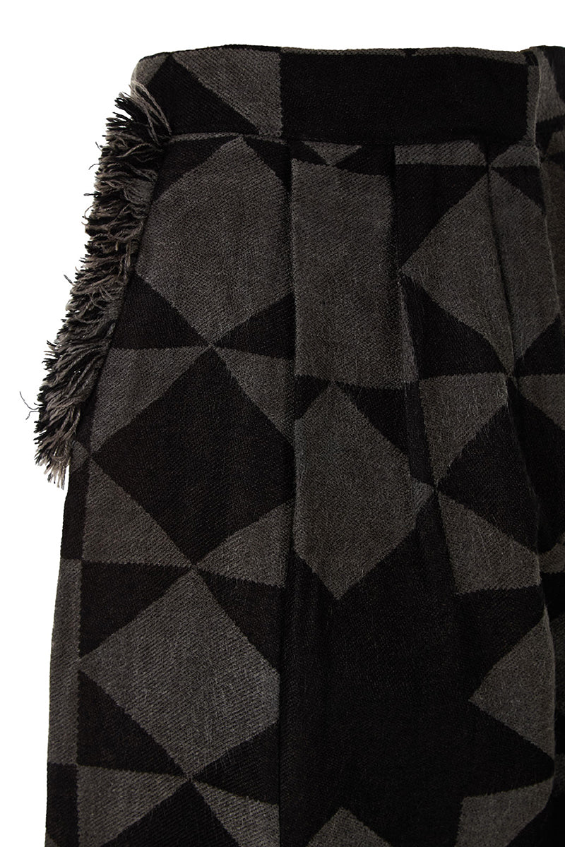 Pair of MAZ Manuela Álvarez baggy pattern pants with a loose fit and colorful geometric design on lightweight fabric.