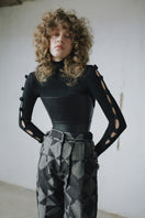 Baggy pattern pants by MAZ Manuela Álvarez featuring a loose fit and bold print, shown on a model in a casual setting.