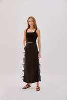 Labeca Carolina Black Linen Bow Midi Skirt featuring a high waist, bow detail, and flowing midi length fabric.